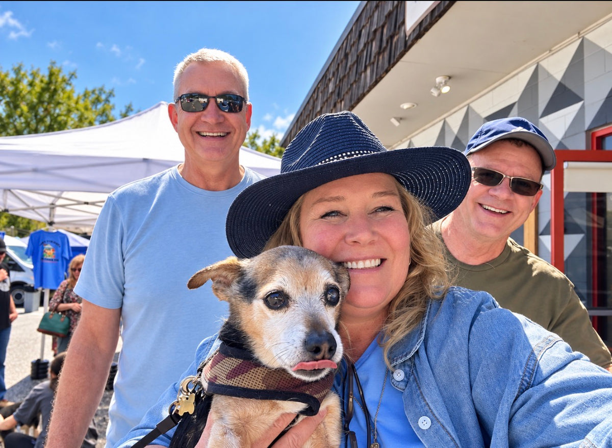 Critter Chef Lindsey holding a dog at a Shinto’s community event